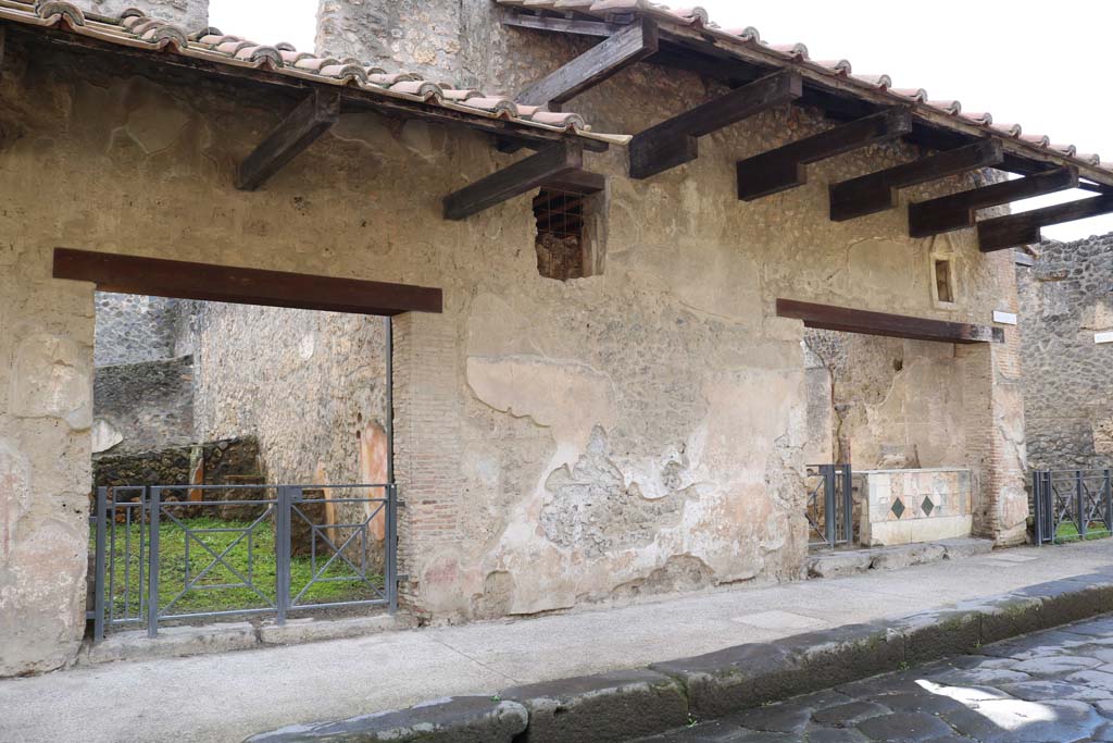 I.11.2, on left, with I.11.1, on right. December 2018. 
The window with grating, as mentioned by Della Corte above, can be seen between the doorways.  Photo courtesy of Aude Durand.