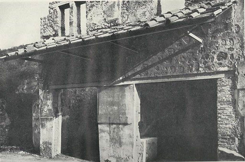 I.11.2 Pompeii, on right. c.1920. Entrance doorways, with entrance doorway to I.11.3, on left. 
The painted electoral programmata are on the pillar between the doorways.