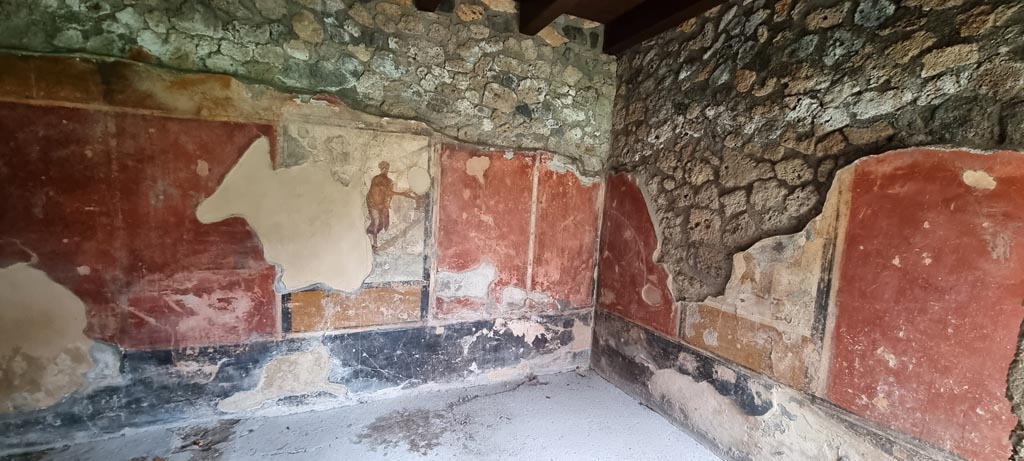 I.11.15 Pompeii. January 2023. 
Room 13, looking towards south wall, south-west corner and west wall. Photo courtesy of Miriam Colomer.