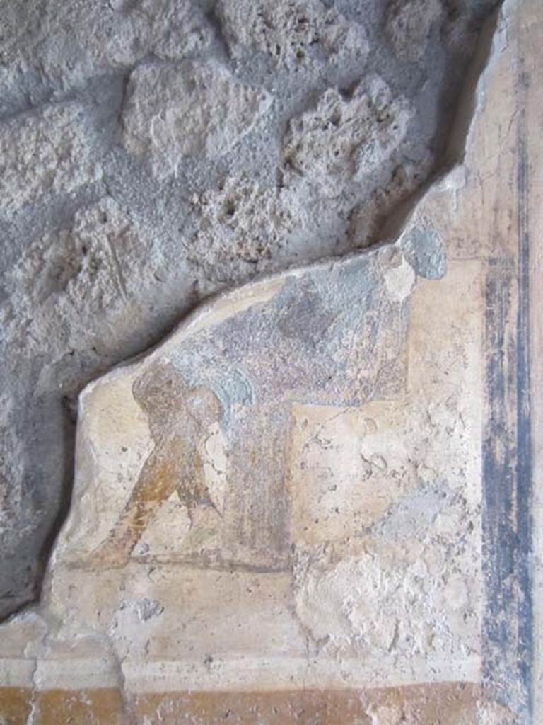 I.11.15 Pompeii. April 2012. Room 13, west wall with detail of remains of wall painting with seated figure dressed in blue cloak. Photo courtesy of Marina Fuxa.