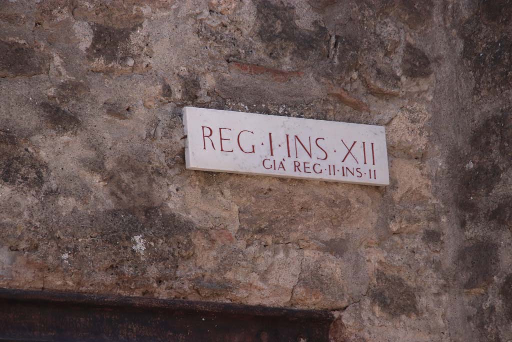 I.12.1 Pompeii. September 2019. 
Insula identification plaque, Reg. I. Ins. X11, previously known as Reg. II, Ins. 11 (which is Reg. II, Ins. 2). 
Photo courtesy of Klaus Heese.