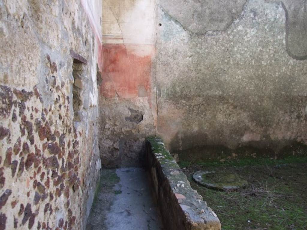 I.12.3 Pompeii. March 2009. Room 6, garden area. 
Looking south along passageway on east side of garden area, and cistern in south-east corner.