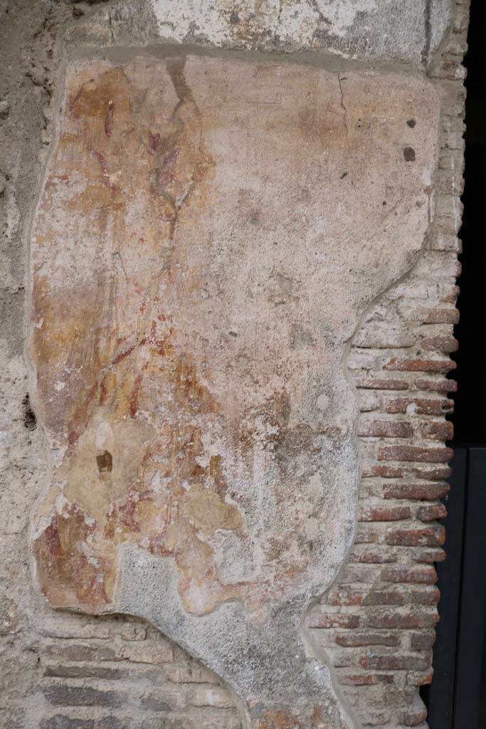 I.12.3 Pompeii. December 2018. 
Detail of remaining plaster on pilaster between doorways I.12.4 and I.12.3. Photo courtesy of Aude Durand.