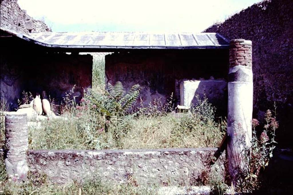 I.12.8 Pompeii, 1978. Looking north across peristyle from south portico with remains of two columns. Photo by Stanley A. Jashemski.   
Source: The Wilhelmina and Stanley A. Jashemski archive in the University of Maryland Library, Special Collections (See collection page) and made available under the Creative Commons Attribution-Non Commercial License v.4. See Licence and use details.
J78f0207