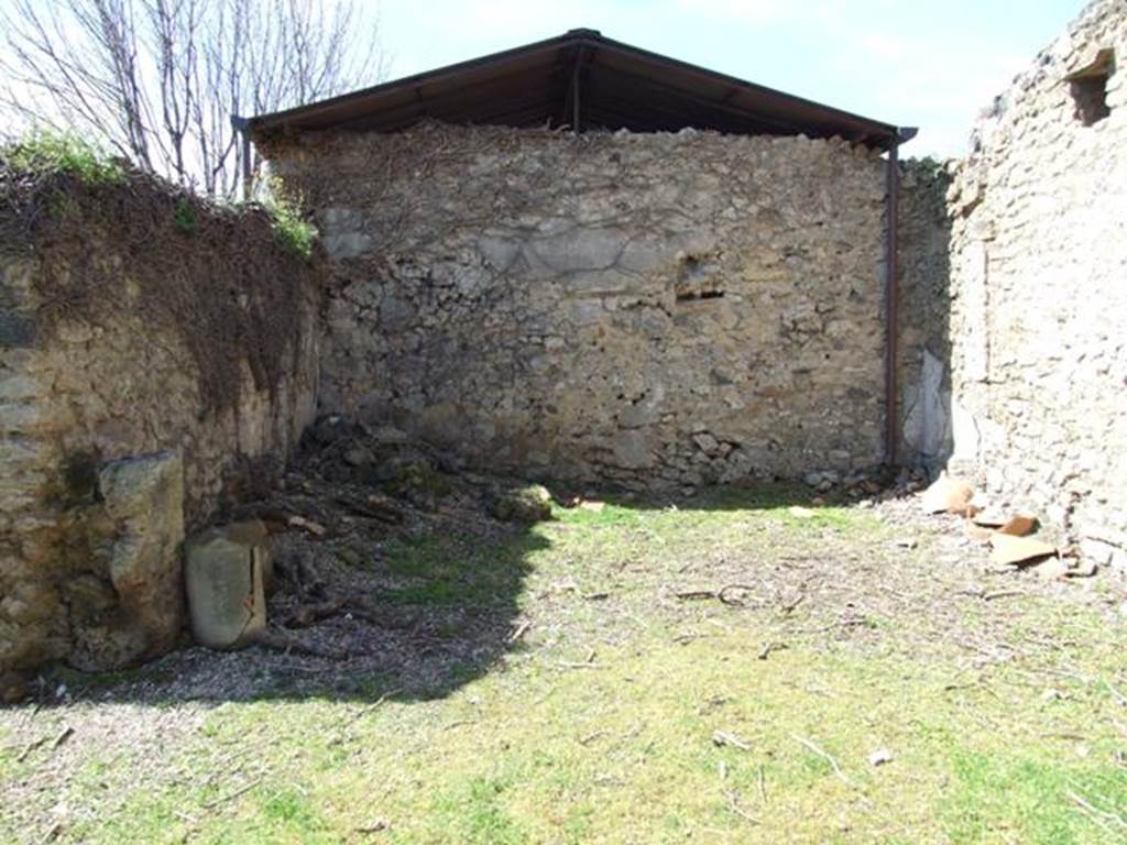 I.12.8 Pompeii. March 2009. Room 13, looking north in rear garden.  
According to Curtis, on Eschebach’s 1969 plan of the house is shown an entrance doorway from the rear garden courtyard leading into the house at I.12.7. 
This is an error.  See Curtis R.L: The Garum shop of Pompeii, In Cronache Pompeiane, V.1979, p.8 note 5.