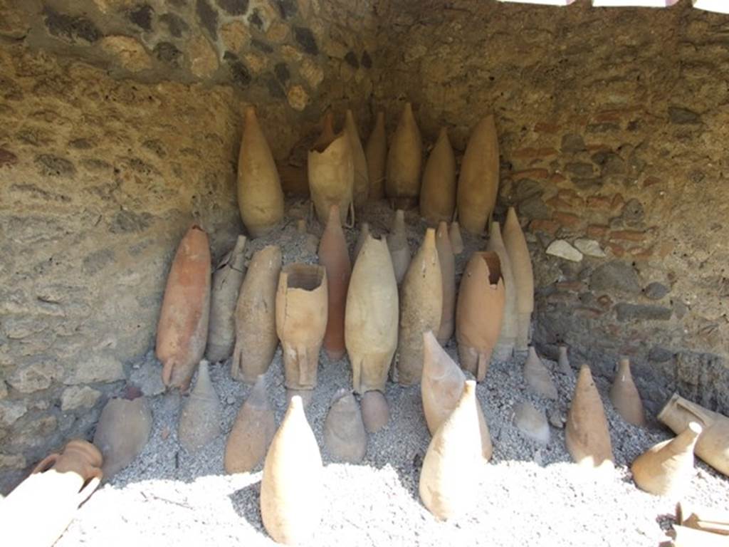 I.12.8 Pompeii. March 2009. Room 13, rear garden with remains of empty amphorae.
According to Curtis, a large number of empty amphorae were excavated especially in the north-east corner where many remain as they were in 79AD, stacked upside down and awaiting re-use. These amphorae came in a variety of sizes and shapes. A few of the amphorae had painted inscriptions relating to their contents, but unfortunately did not show any inscriptions that would permit the identification of the owner of this garum shop. See Curtis R.L: The Garum shop of Pompeii, In Cronache Pompeiane, V.1979, p.13-4 and note 12.