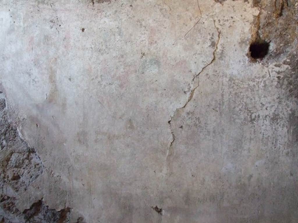 I.12.9 Pompeii. December 2007. East wall of kitchen. According to PPP and Giacobello, on the east wall of the kitchen above the bench was a lararium, now completely disappeared. According to PPP, the Lararium was shown with altar, offerings, a Lar, and a decayed serpent.
According to Giacobello, in the upper part was the figure of the Genius sacrificing near an altar. He was assisted by two people, presumably the camillo and the tibicine. On his left, was a painted Lar with his arm held high, near to him was a large ham. Upon discovery, the serpent near an altar in the lower zone was only partially conserved.  See Giacobello, F., 2008. Larari Pompeiani: Iconografia e culto dei Lari in ambito domestico.  Milano: LED Edizioni. (p.153)   See Bragantini, de Vos, Badoni, 1981. Pitture e Pavimenti di Pompei, Parte 1. Rome: ICCD. (p.176)