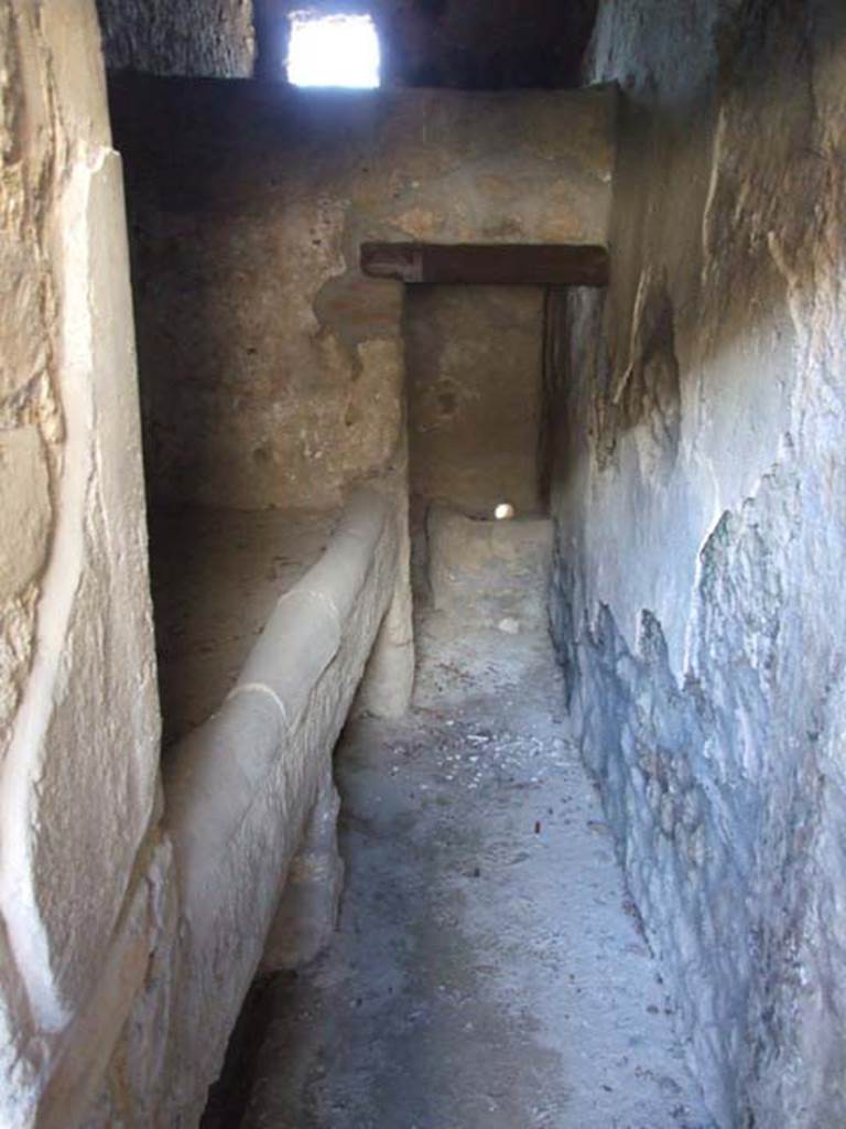 I.12.11 Pompeii. March 2009. Kitchen in north-west corner with hearth and doorway to latrine.