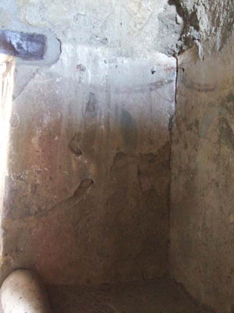 I.12.11 Pompeii. March 2009. Kitchen, east wall, lararium painting with painted garlands.