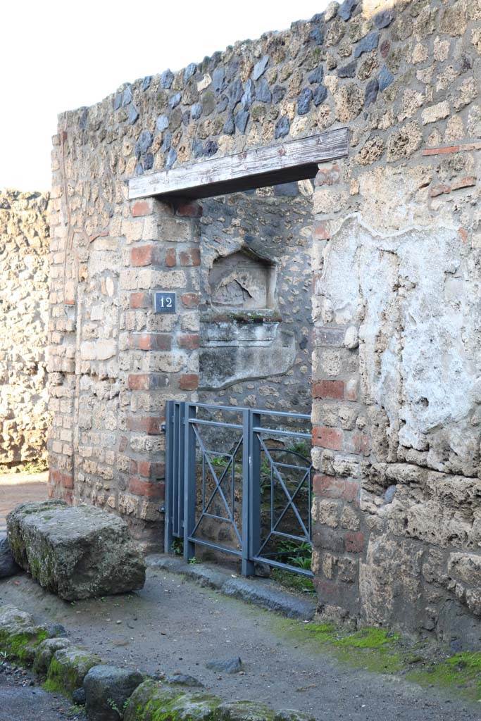 I.12.12 Pompeii. December 2018. 
Entrance doorway on north side of Via di Castricio. Photo courtesy of Aude Durand.