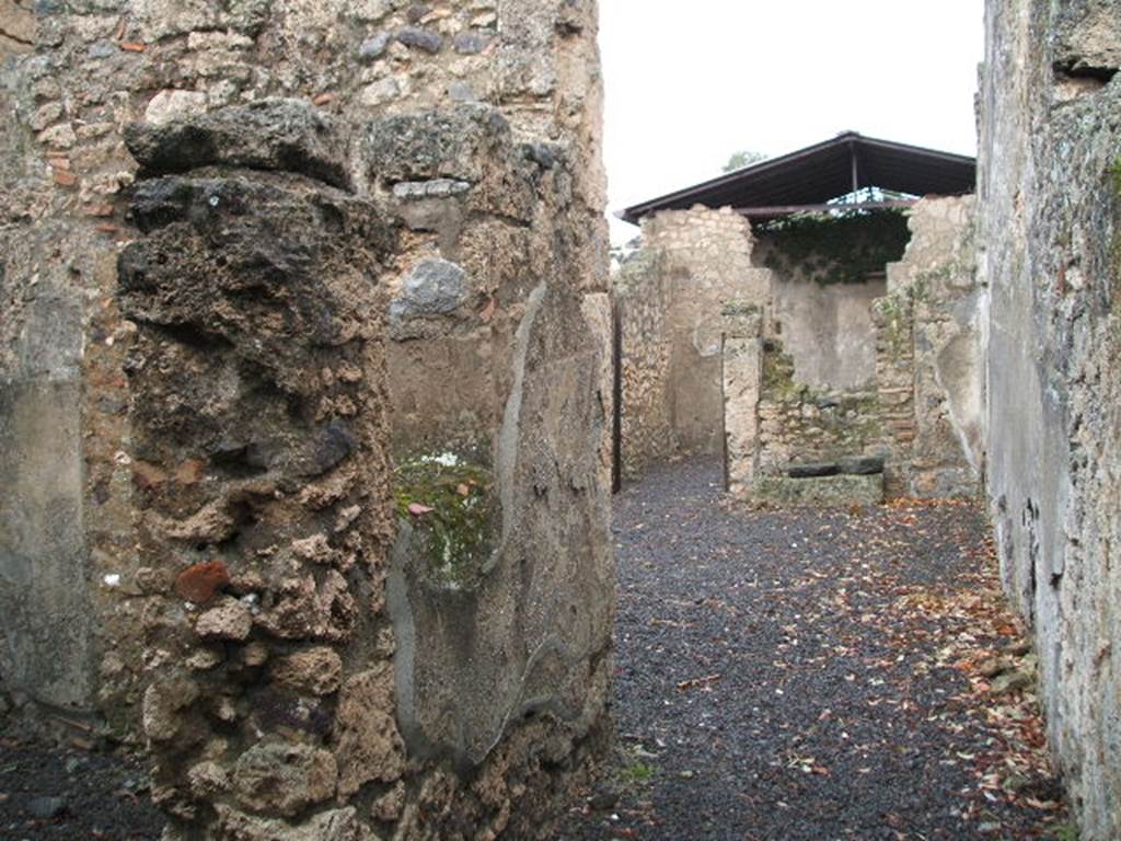 I.12.15 Pompeii. December 2004. Entrance fauces, looking east. The doorway to room 2, a cubiculum is on the left, and the atrium is ahead.