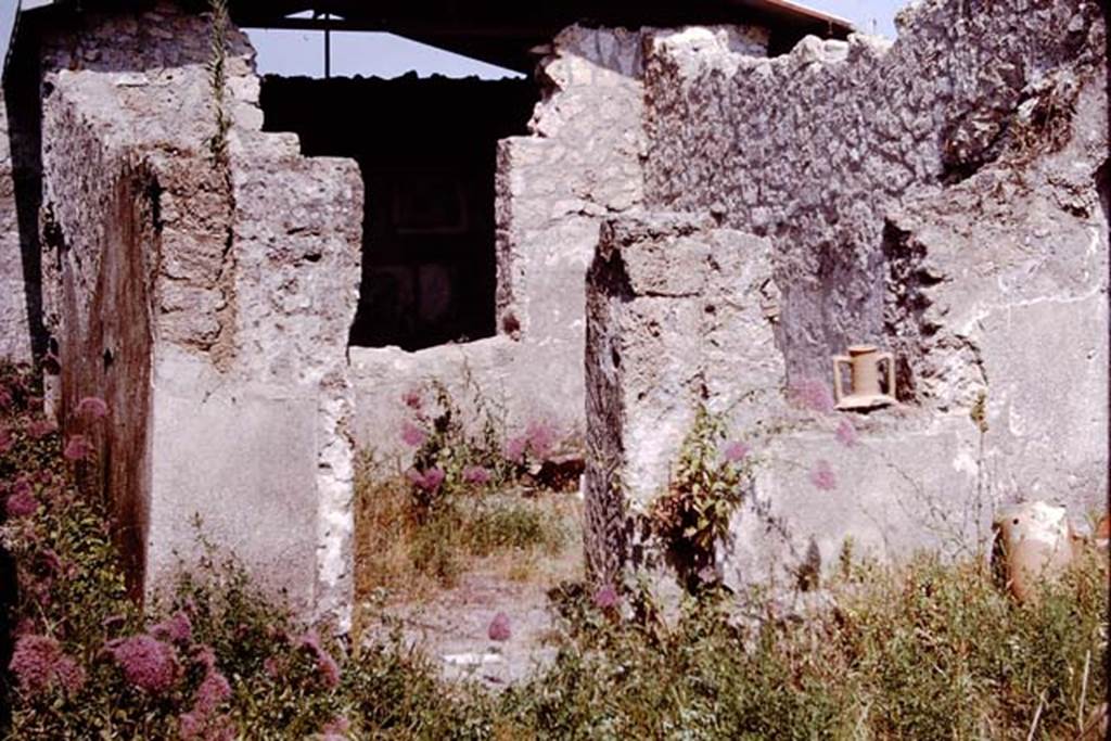 I.12.15 Pompeii. 1964. Looking east in atrium to doorway to room 3, windowed triclinium, in centre, and room 4, corridor, on left.    Photo by Stanley A. Jashemski.
Source: The Wilhelmina and Stanley A. Jashemski archive in the University of Maryland Library, Special Collections (See collection page) and made available under the Creative Commons Attribution-Non Commercial License v.4. See Licence and use details.
J64f1568