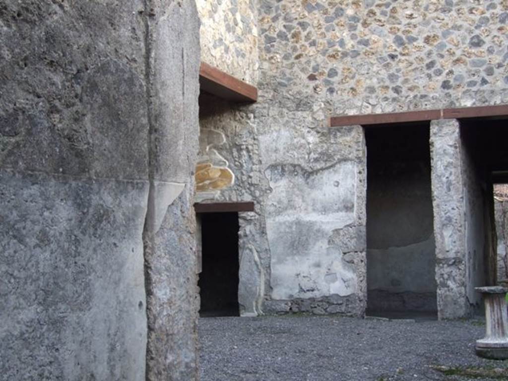 I.13.2 Pompeii. December 2007.  
Looking south-east across atrium towards small doorway on south wall of ala leading to an anteroom before an oecus, and large doorway to a small closed tablinum.