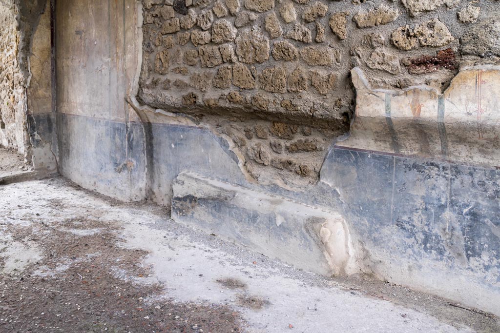 I.13.2 Pompeii. March 2023. Detail of lower west wall of triclinium, looking south. Photo courtesy of Johannes Eber.