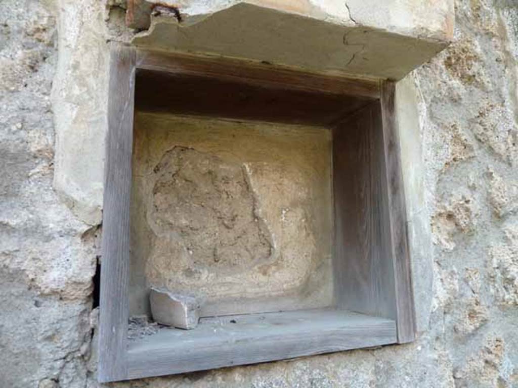 I.13.2 Pompeii. May 2010.  Niche of Lararium.
According to Jashemski, a bronze statuette of Athena, SAP inventory number 10560, was found here.
It was on a base with the inscription THEODOR MAS.
See Jashemski, W. F., 1993. The Gardens of Pompeii, Volume II: Appendices. New York: Caratzas. (p.56).