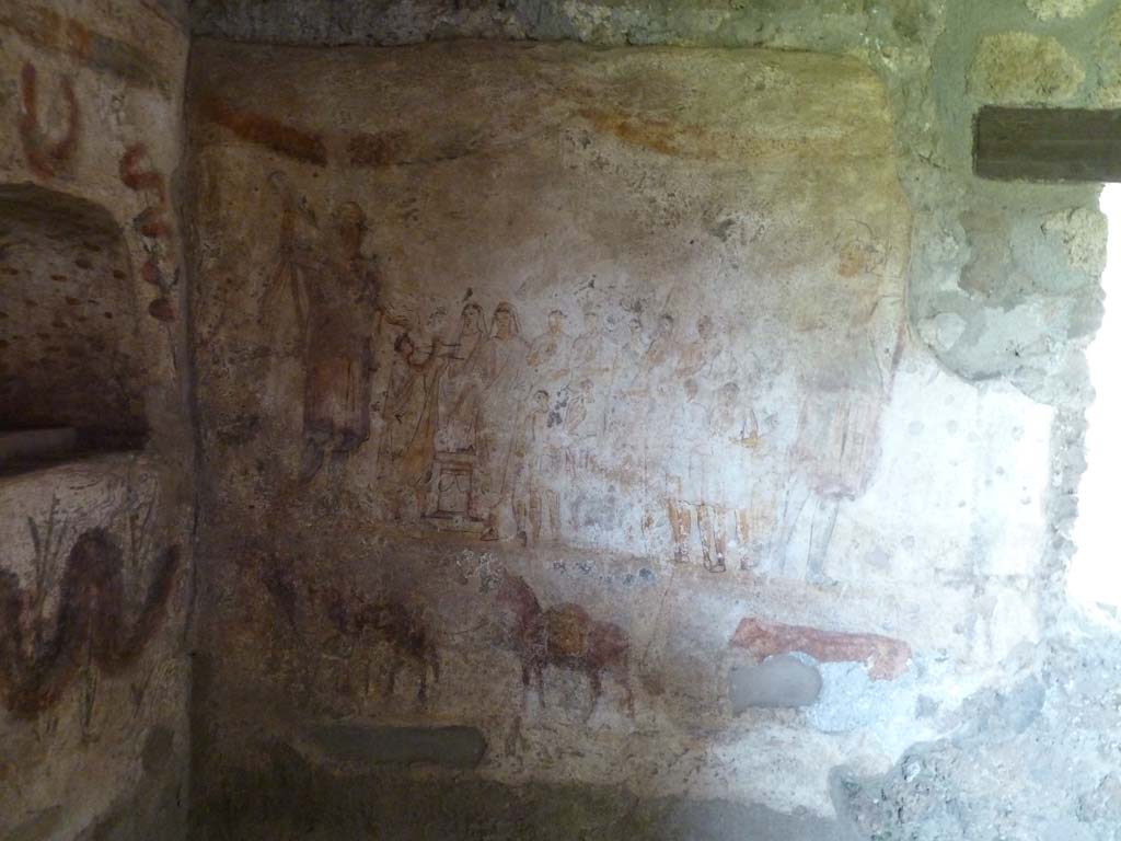 I.13.2 Pompeii. May 2010. 
East wall of kitchen with lararium painting showing the matron of the house with her entire family offering sacrifice at the Caristia, a ritual celebrating family and held on February 22. (Fig 35.1 on page 541).
See Dobbins, J & Foss, P., 2008. The World of Pompeii. New York: Routledge. (p.534)
