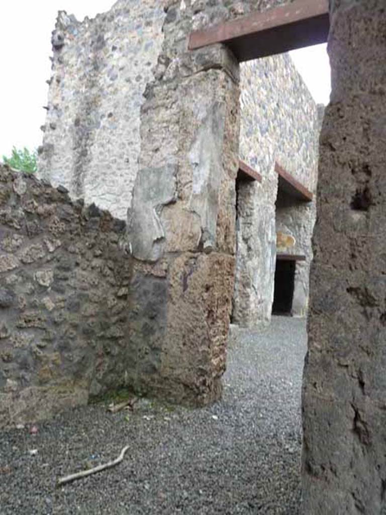 I.13.2 Pompeii. May 2010. South end of small room, with doorway to atrium.
The doorway, to the second room on the left of the atrium, can be seen through this doorway and then followed by the left ala with a small doorway.