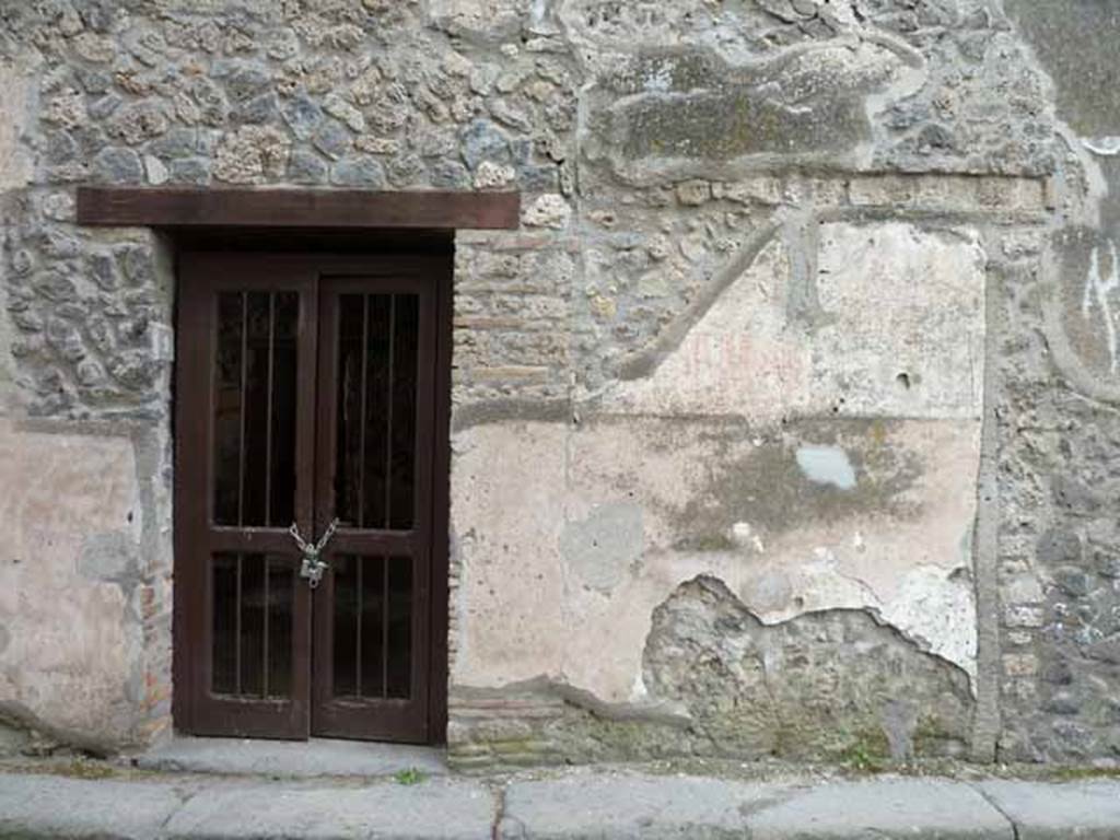 I.13.9 Pompeii. May 2010. North side of entrance doorway, with remains of painted graffiti.