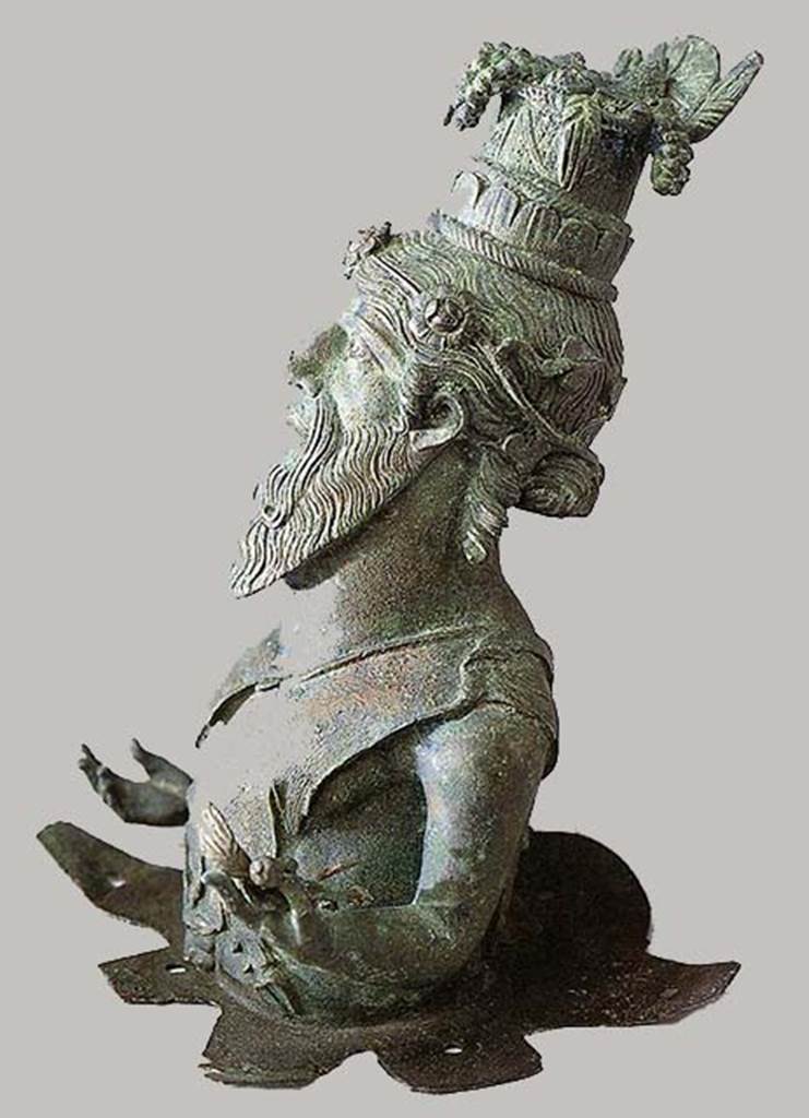 I.13.9 Pompeii, Bust of Dionysus-Sabazius, side view. SAP inventory number 11471.
According to Berry, he wears a tall fruit basket as a hat. 
From it overflow grapes, figs, plums, ears of wheat and a loaf of bread, all symbols of fertility.
The figure was originally mounted on a wooden pole.
See Berry, J., 2007. The Complete Pompeii. London: Thames & Hudson, p. 200.