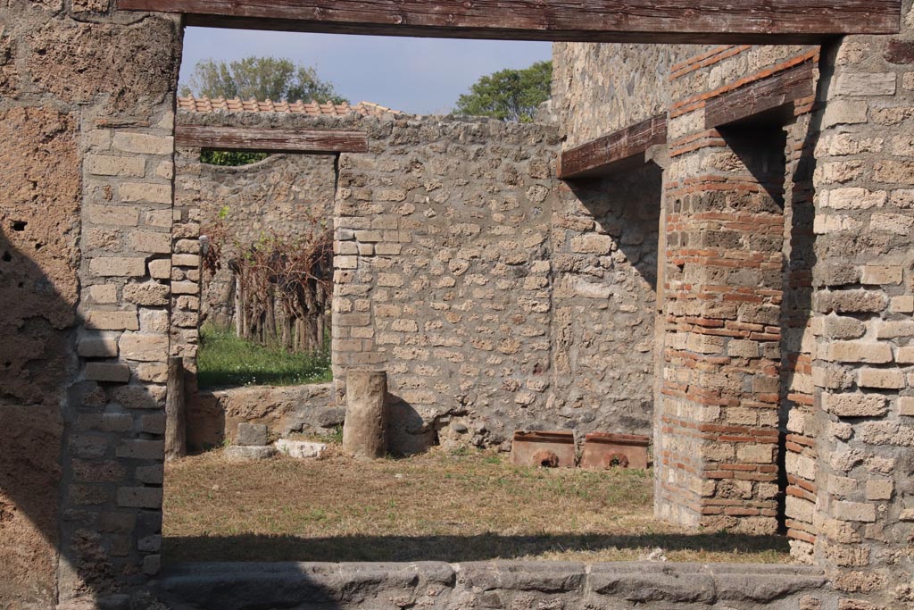 I.13.12 Pompeii. October 2023. 
Looking north through window/doorway from atrium towards garden area, at I.13.14. Photo courtesy of Klaus Heese.