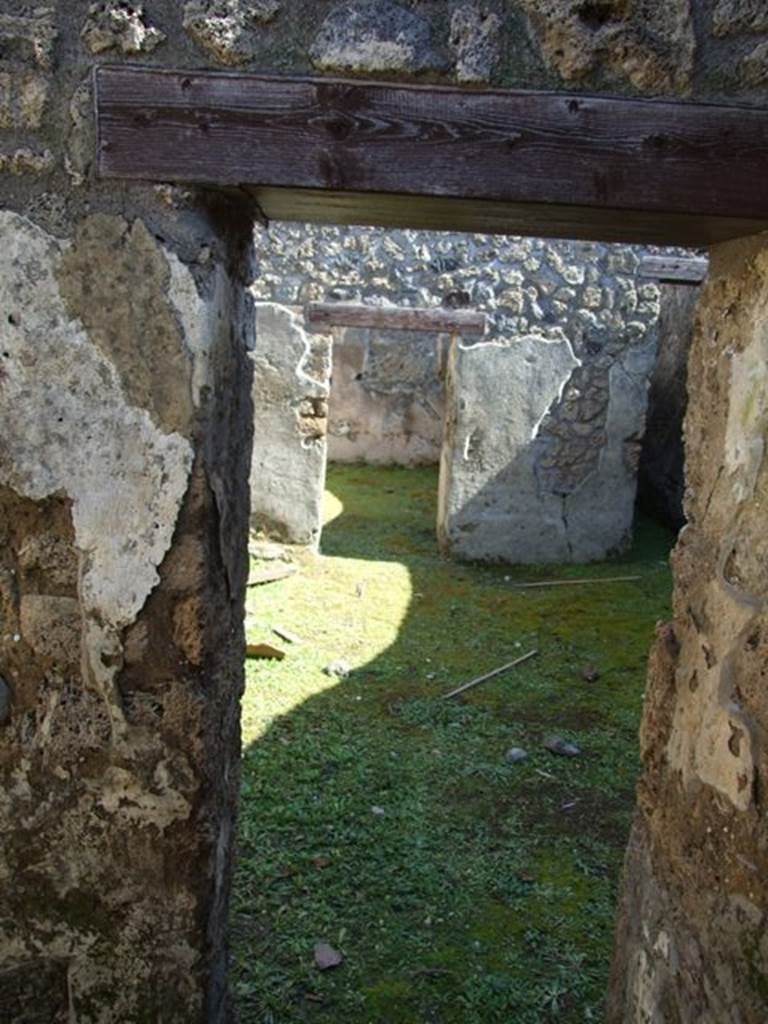 I.13.15 Pompeii. March 2009. Room on north side of entrance. Looking east from doorway from room across central courtyard.