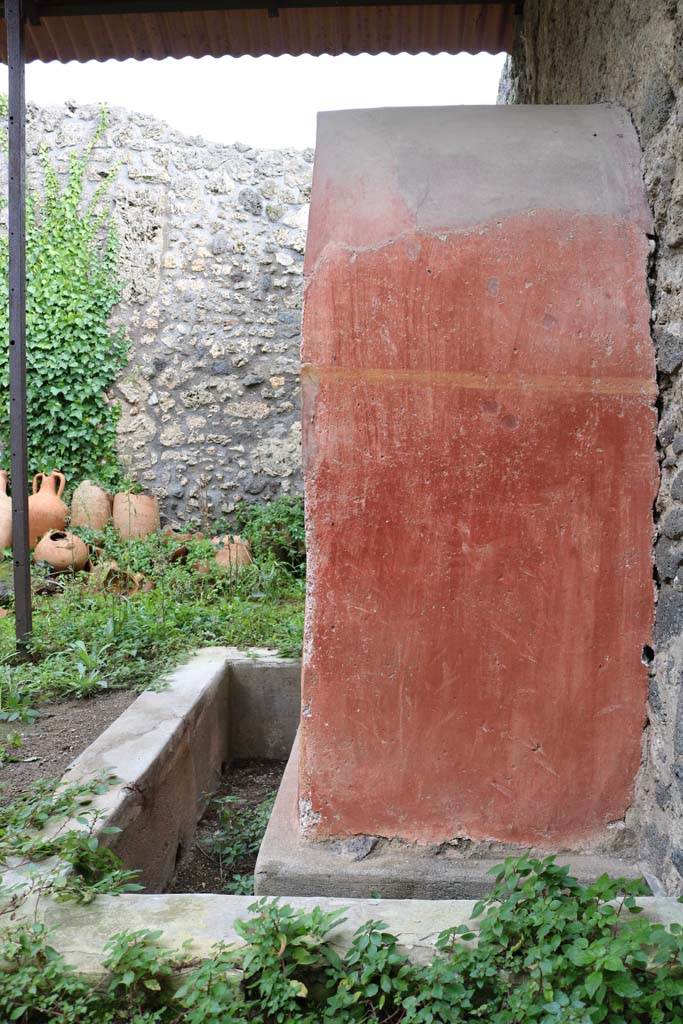 I.14.7 Pompeii. December 2018. 
West outer side of the lararium, with faded painted plants. Photo courtesy of Aude Durand.