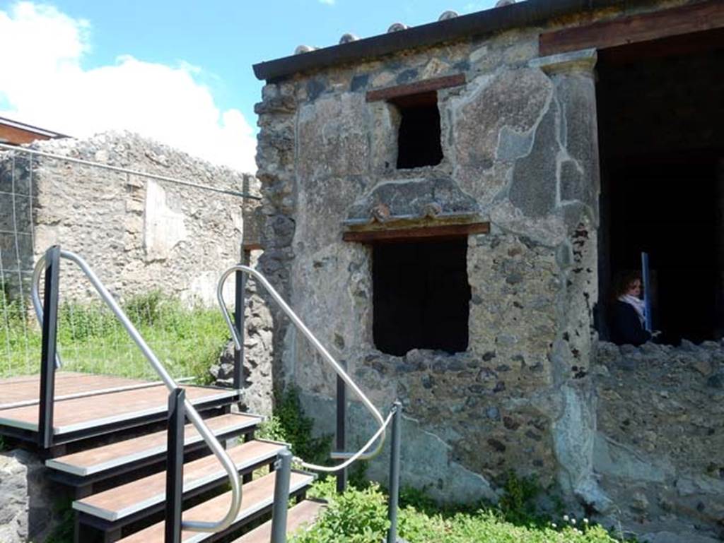 I.14.12, Pompeii. May 2018. Stairs to I.14.1 (blocked), looking towards exterior east wall of garden area, with window into room 2, in centre, and 32, on right.
Photo courtesy of Buzz Ferebee.