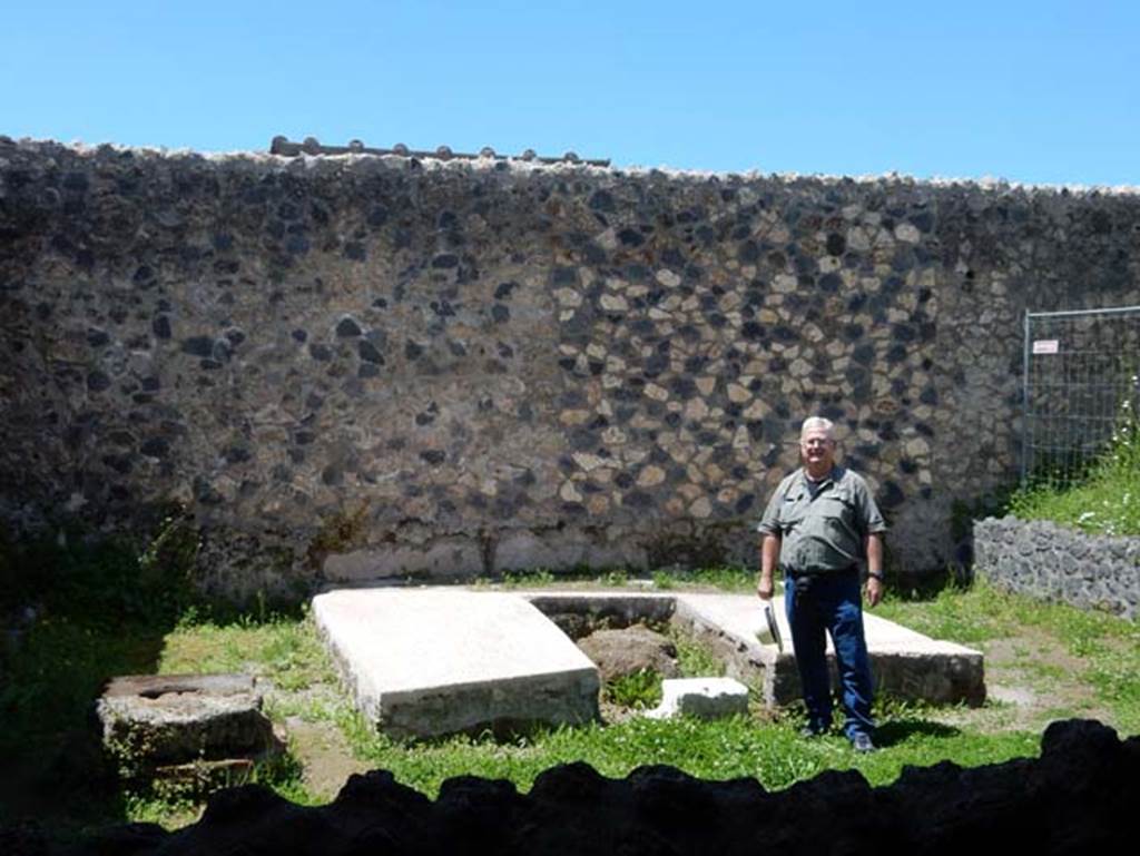 I.14.12, Pompeii. May 2018. Buzz being tempted by a sit down on the triclinium couches after all his hard work, only joking! Photo courtesy of Buzz Ferebee