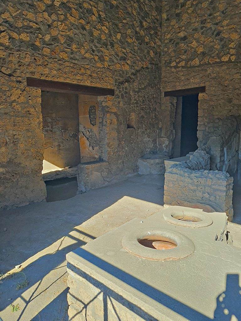 I.14.15 Pompeii. October 2024.
Looking towards west side of bar-room, with doorways to rooms on west and north side.
Photo courtesy of Giuseppe Ciaramella.