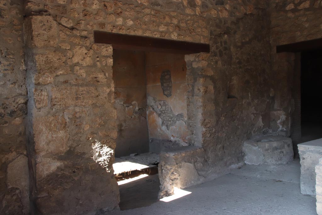 I.14.15 Pompeii. October 2022. 
Looking towards west side of bar-room with doorways to room on west side, in centre. Photo courtesy of Klaus Heese.