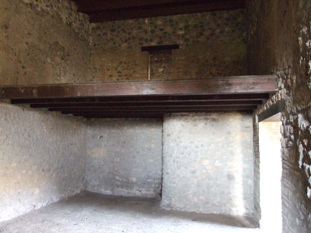I.15.3 Pompeii. December 2007. Room 11 in south-west corner of peristyle, next to kitchen. 
The stairs in the kitchen, room 9, would have led to the door on the upper floor. Looking north.