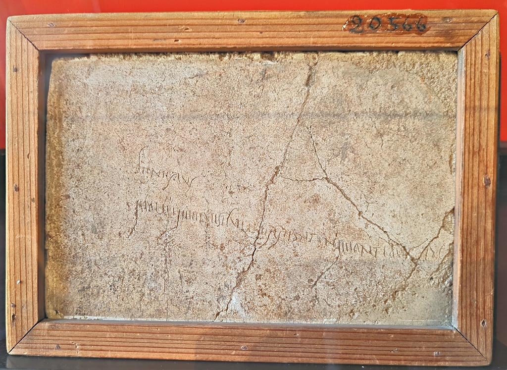 I.15.3 Pompeii. March 2024. 
No.1 on information card below. Graffito with a verse from Vergil 1Ist century AD). Photo courtesy of Giuseppe Ciaramella.
On display in exhibition in Palaestra entitled – “L’altra Pompei, vite comuni all’ombra del Vesuvio”.