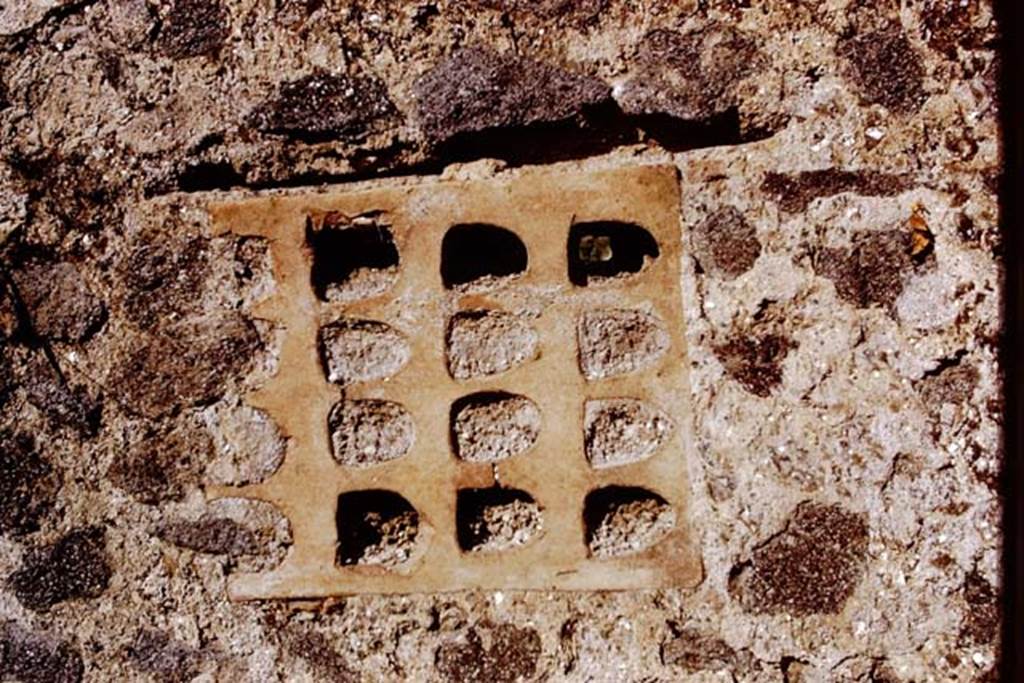 I.15.3 and I.15.5/6 Pompeii. 1972. Terracotta window from south end of rear wall of I.15.5/6. Photo by Stanley A. Jashemski. 
(Note: On first view we thought this photo was sideways on, but looking at the photo two above of the wall, this is the way it is in the wall.)
Source: The Wilhelmina and Stanley A. Jashemski archive in the University of Maryland Library, Special Collections (See collection page) and made available under the Creative Commons Attribution-Non Commercial License v.4. See Licence and use details.
J72f0612