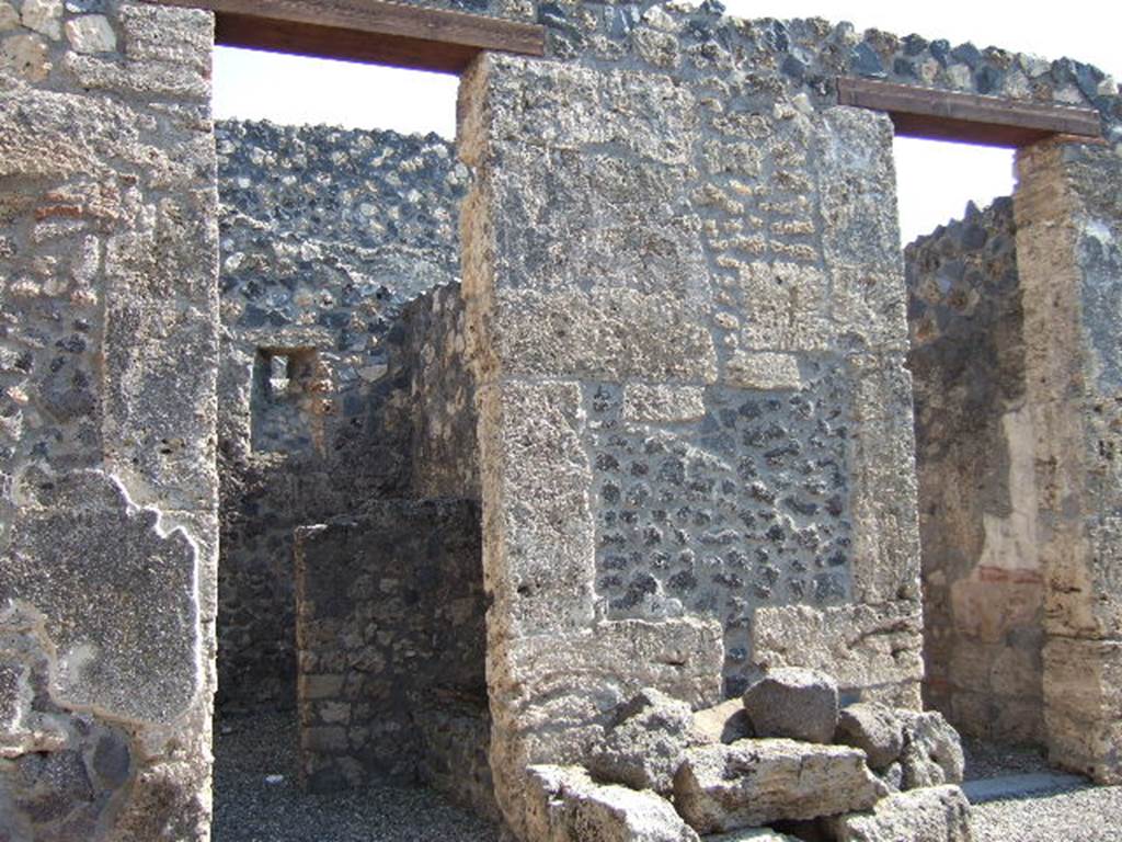 I.16.2 Pompeii. September 2005. Doorways on east side of peristyle in north-east corner.
On the left is the doorway to the services area.
