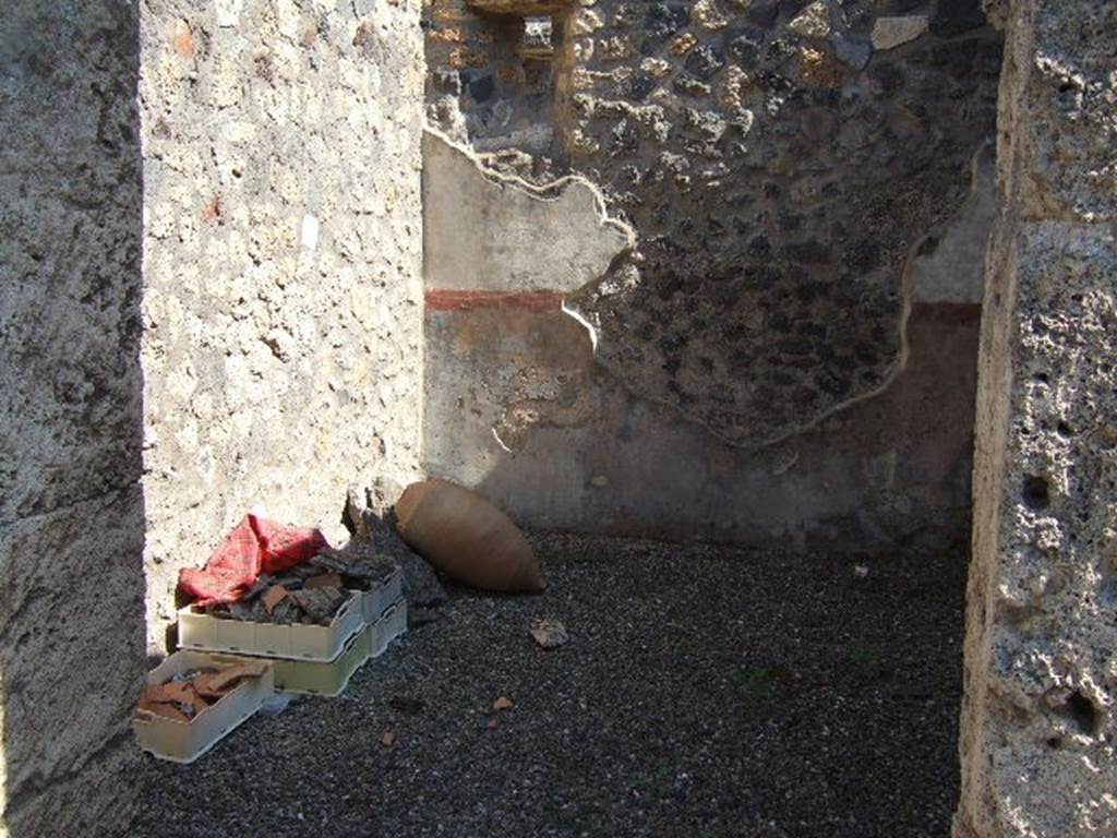 I.16.2 Pompeii. December 2006. Looking into room on east side of peristyle.
The room would have had walls painted with a high black zoccolo with panels edged with a red band. 
The middle zone of the walls would have been painted white, with panels edged in red.