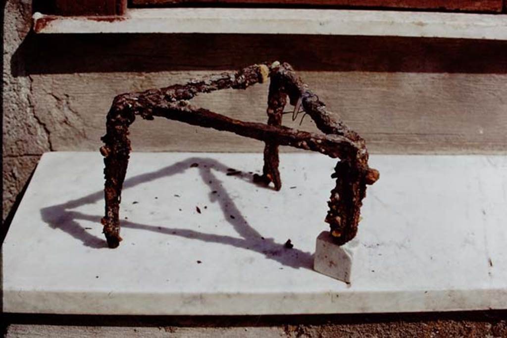 I.20.5 Pompeii. 1973. Iron tripod used for cooking. Photo by Stanley A. Jashemski. 
Source: The Wilhelmina and Stanley A. Jashemski archive in the University of Maryland Library, Special Collections (See collection page) and made available under the Creative Commons Attribution-Non Commercial License v.4. See Licence and use details. J73f0570