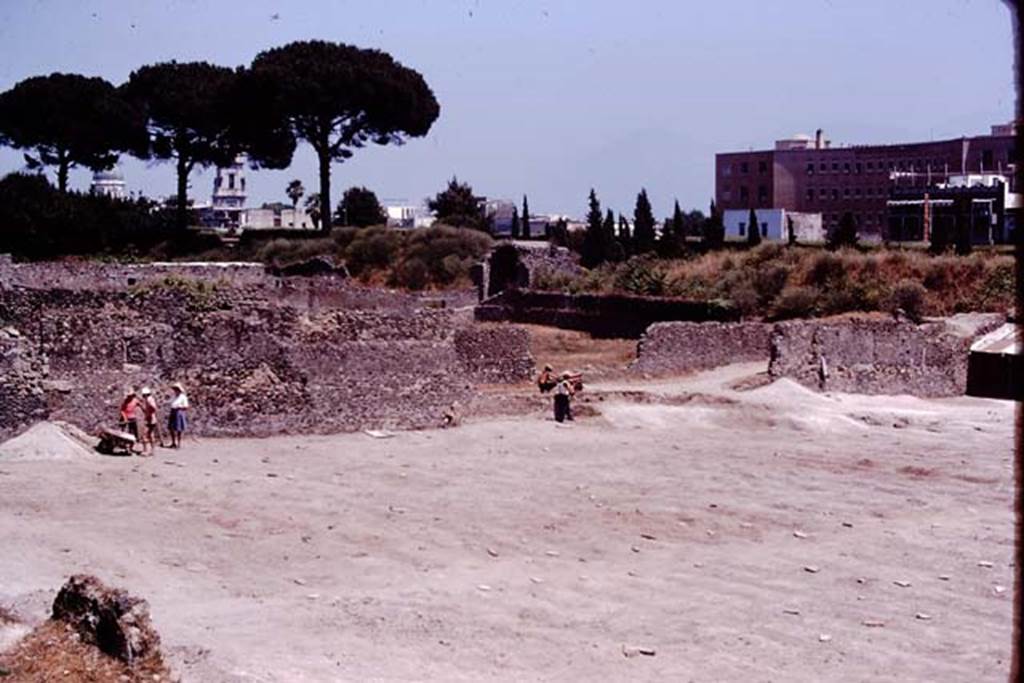 I.21.6 Pompeii. 1974. Looking south-east across site towards rear of I.20.1, with Porta Nocera (in centre). Photo by Stanley A. Jashemski.   
Source: The Wilhelmina and Stanley A. Jashemski archive in the University of Maryland Library, Special Collections (See collection page) and made available under the Creative Commons Attribution-Non Commercial License v.4. See Licence and use details. J74f0241