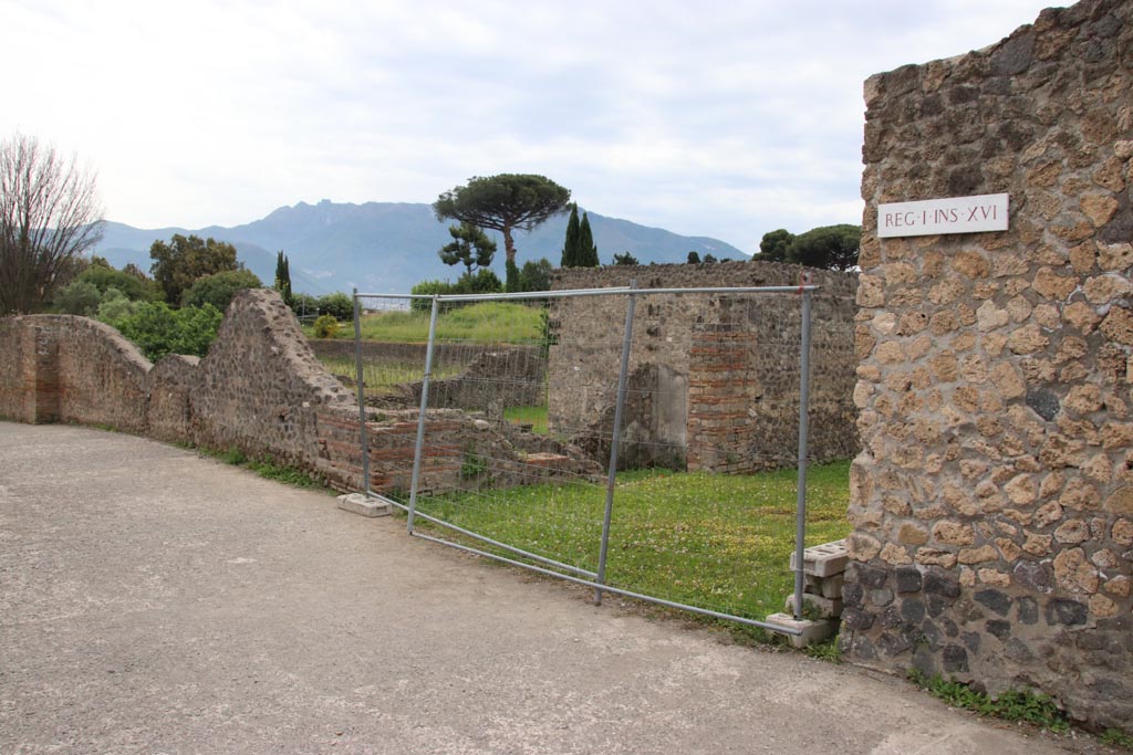 .22.3 Pompeii, on left. May 2024.
Looking south-west towards corner of insula at junction of Vicolo della Nave Europa, on left, and Via della Palestra, in centre.  
Photo courtesy of Klaus Heese.