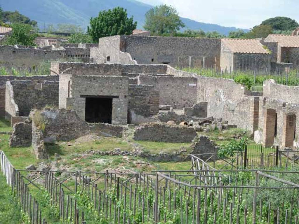I.22.3 Pompeii. May 2010. Looking north-east from the rear towards the corner of the insula.
