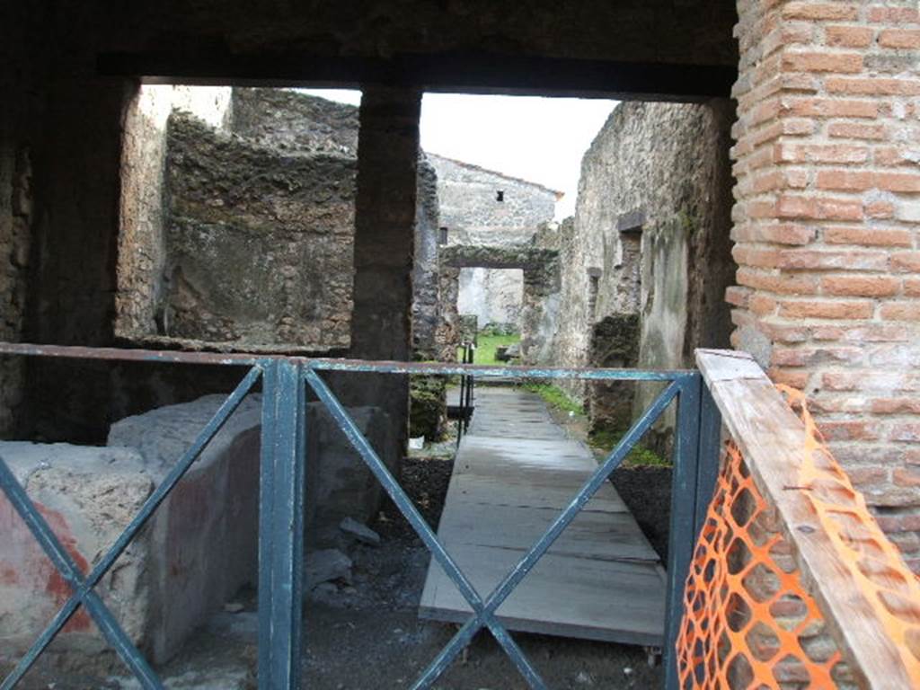 II.1.1 Pompeii. December 2004. Looking south towards rear and II.1.13. According to Jashemski, the living quarters behind the bar, linked to II.1.13, had a small garden in the rear south-east corner. The east wall had broken amphoras inserted in its top. See Jashemski, W. F., 1993. The Gardens of Pompeii, Volume II: Appendices. New York: Caratzas. (p.75)