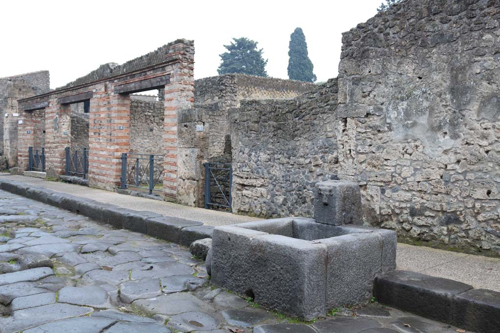 II.1.6, on left to II.1.3, in centre, Pompeii. December 2018 
Looking south-east on south side of Via dell’Abbondanza, from fountain. Photo courtesy of Aude Durand.