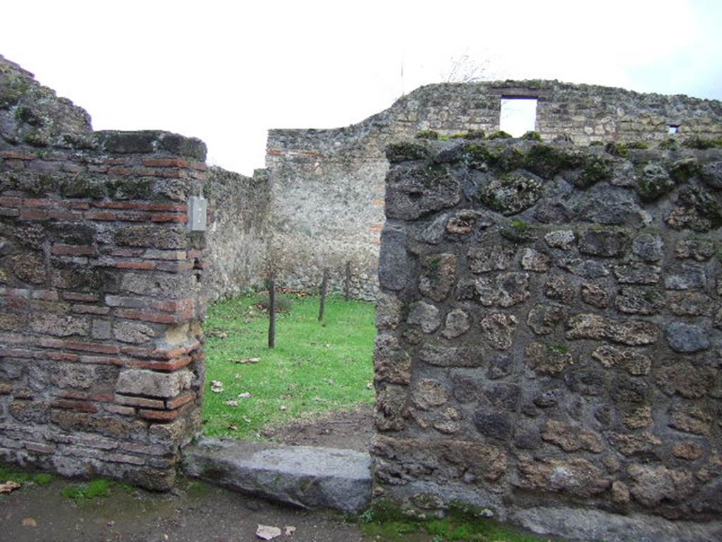 II.1.7 Pompeii. December 2005. Entrance with narrowed doorway, the original threshold extends to the right.