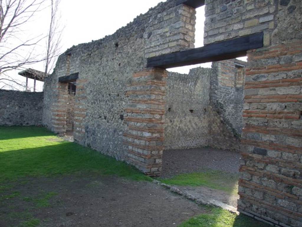 II.1.7 Pompeii. December 2007. Looking south-west, from II.1.6. West wall of garden showing rear doorway from house on left, and linked access to II.1.3 and II.1.4 on the right.
