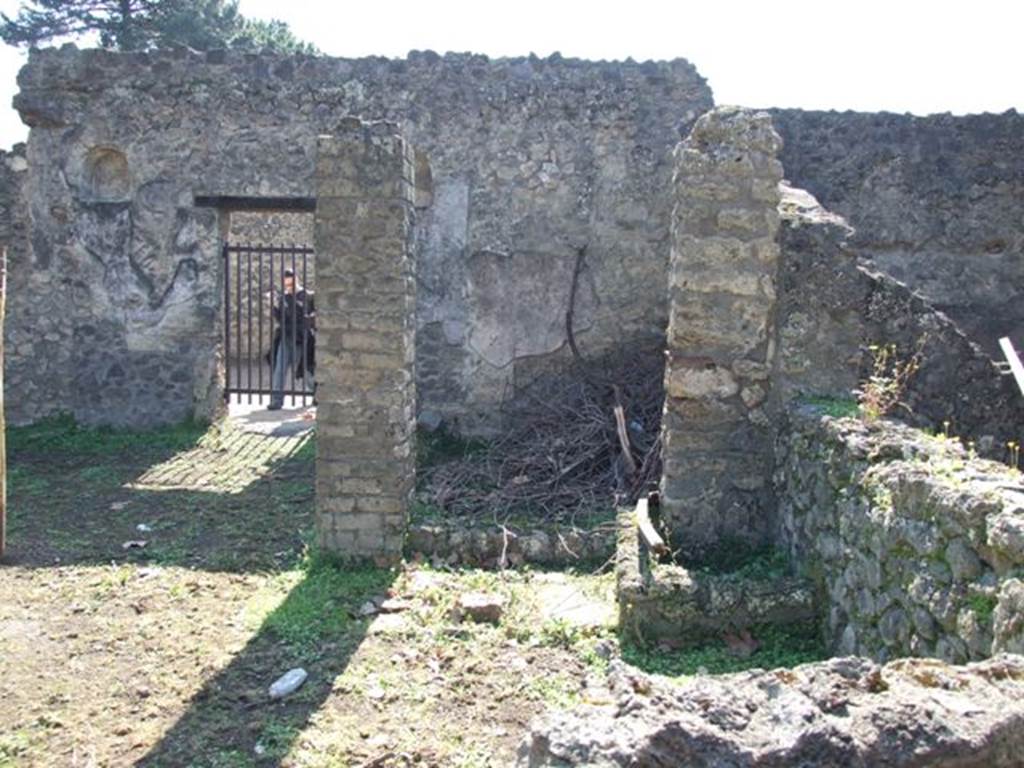 II.1.9 Pompeii.  March 2009.  Looking south from Latrine to Room 7, small room on south side of garden, and rear door at II.1.8