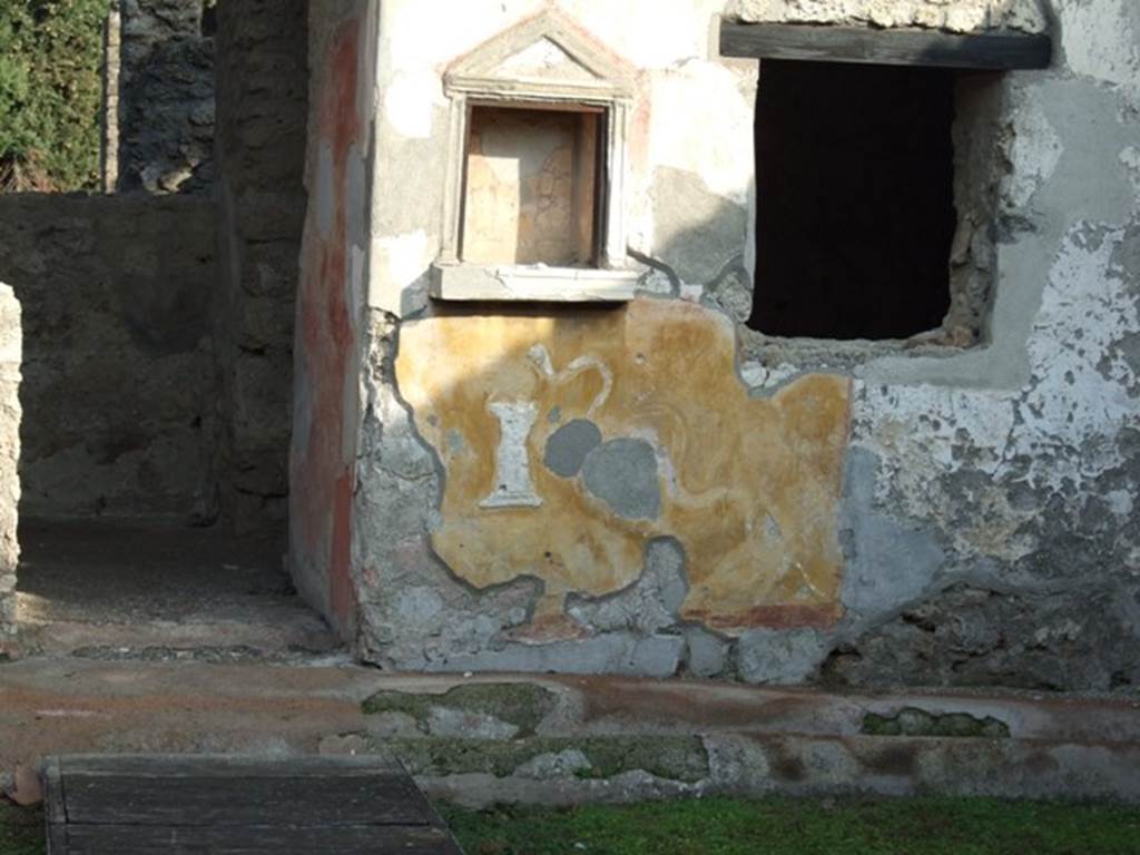 II.1.9 Pompeii. December 2007. Lararium.  Between the niche and the window was a painting of Hercules standing with his club, now faded or missing.   
See Fröhlich, T., 1991, Lararien und Fassadenbilder in den Vesuvstädten.  Mainz: von Zabern.  (L39, p.265, T. 29, 4).
See Rivista di Study Pompeiani, X, 1999, Un ensemble de pots à peinture à Pompéi, by Barbet, Tuffreau-Libre, Coupry. (p.71-81). SAP photo of lararium upon excavation, and a drawing of it by Barbet, can be seen on pages 74 and 75.