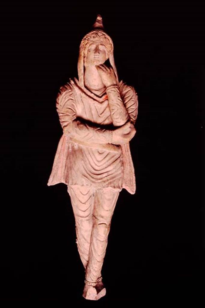 Pompeii, 1982 or 1983. Terracotta statuette of Attis discovered in the area “next to the wall of the ancient well”.   
This is the first of two statuettes found. SAP inventory number 10309.
Source: The Wilhelmina and Stanley A. Jashemski archive in the University of Maryland Library, Special Collections (See collection page) and made available under the Creative Commons Attribution-Non Commercial License v.4. See Licence and use details.
J80f0498
See D’Ambrosio A. and Borriello M., 1990. Le terrecotte figurate di Pompei: SAP cat. 4. Roma: L’Erma di Bretschneider, p. 23, n. 16, Tav. V.