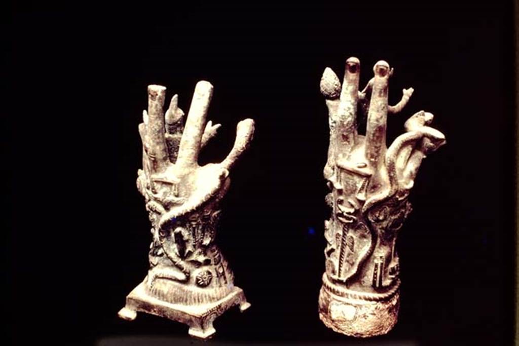 II.1.12 Pompeii, 1978. Cult objects, the reverse of the two bronze hands. Photo by Stanley A. Jashemski.   
Source: The Wilhelmina and Stanley A. Jashemski archive in the University of Maryland Library, Special Collections (See collection page) and made available under the Creative Commons Attribution-Non Commercial License v.4. See Licence and use details. J78f0418