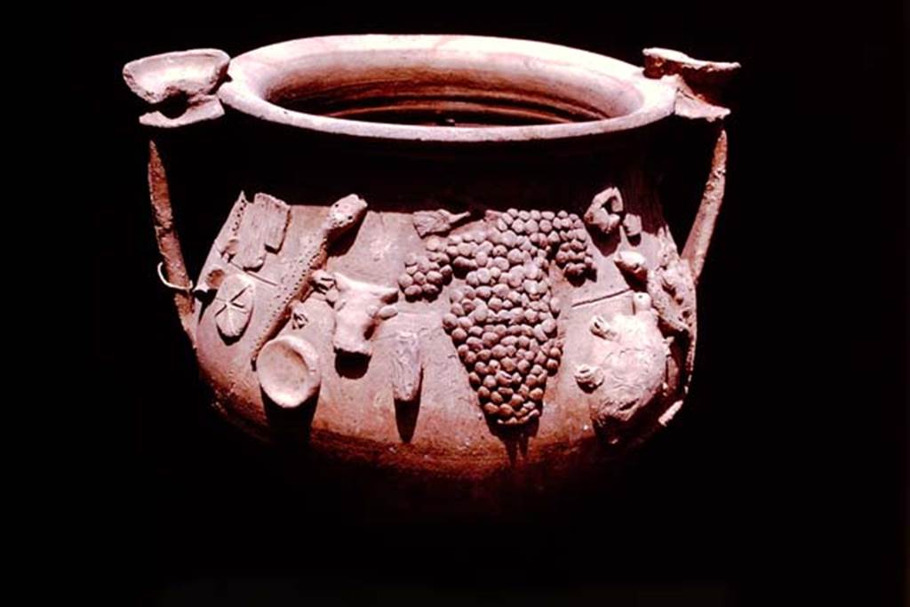 II.1.12 Pompeii, 1978. Terracotta vase found with other cult objects. Photo by Stanley A. Jashemski.   
Source: The Wilhelmina and Stanley A. Jashemski archive in the University of Maryland Library, Special Collections (See collection page) and made available under the Creative Commons Attribution-Non Commercial License v.4. See Licence and use details. J78f0591