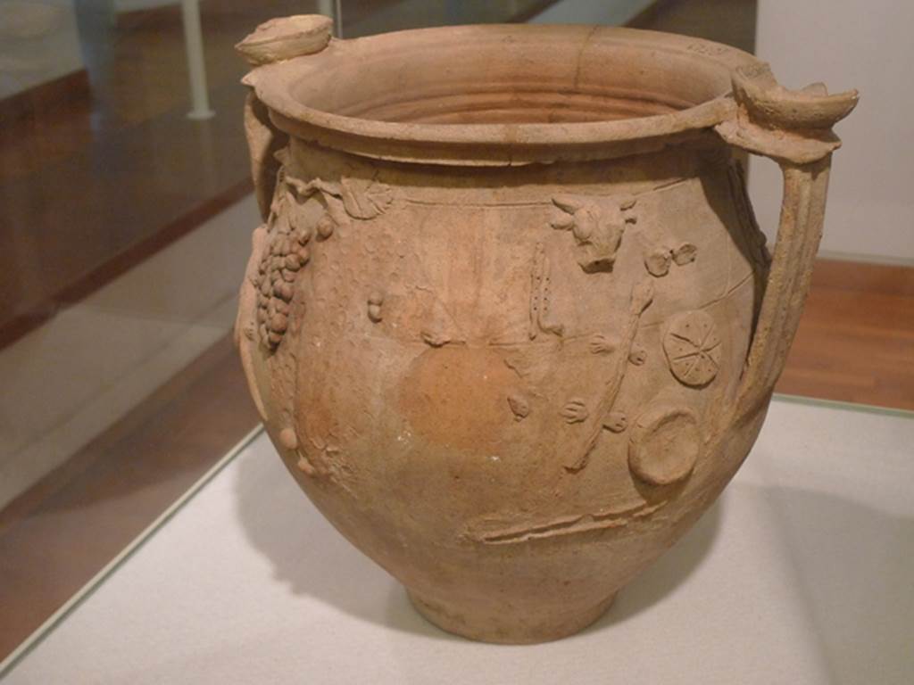 II.1.12 Pompeii. Cult Vase found 9th February 1954 in the immediate vicinity of the altar. 
Right hand end of side 1. Now in Boscoreale Antiquarium. Inventory number SAP 10529.
Photo courtesy of Michael Binns.
See Cicirelli, C., Religio: feste e rituali del culto pubblico e privato, in Cibi e Sapori a Pompei e Dintorni, Exhibition Catalogue 2005. (p.35).
See Conticello, B., Ed, 1990. Rediscovering Pompeii. Rome: L’Erma di Bretschneider. (p.146-47, Fig. 12) 
Note: photo 12 on page 146 is incorrect as it has been flipped horizontally in printing.
Photo 12 on page 147 is correctly printed.