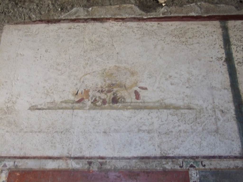 II.1.12 Pompeii. March 2009. Upper wall of south wall of triclinium with wall painting of a fallen basket and dates.